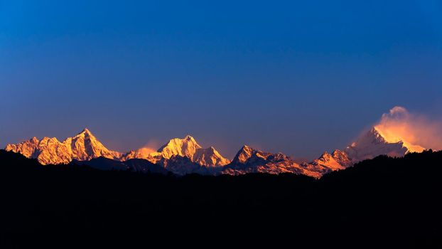 The majestic Kanchenjunga range of the himalayas at first light of sunrise at Sikkim , India