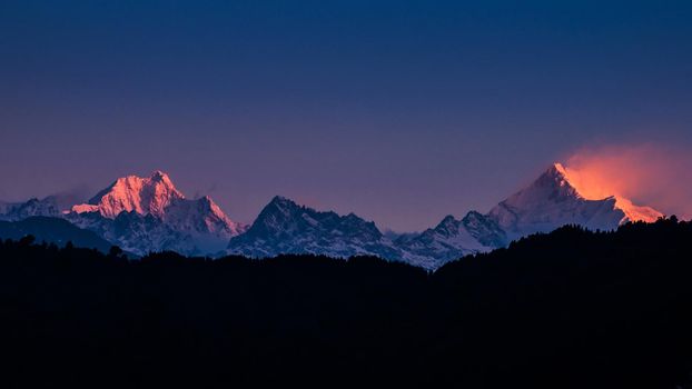 The majestic Kanchenjunga range of the himalayas at first light of sunrise at Sikkim , India

