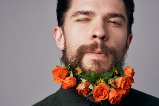 Elegant man black shirt flowers in a beard decoration romance attractive look. High quality photo