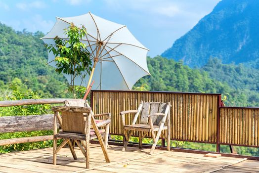 Wooden chair for tourist relaxation with nature view at viewpoint at mountains area in Chiang Mai,Thailand.