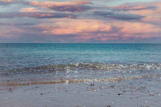 Seascape with a beautiful pink sunset. Travel and tourism