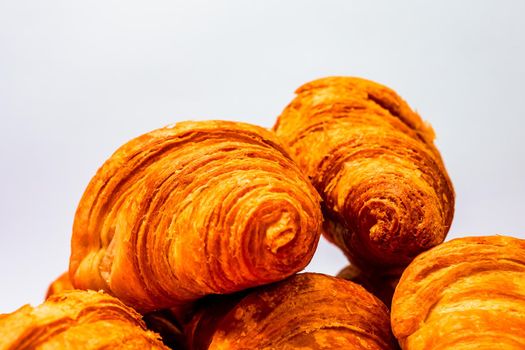 Fresh and delicious croissants isolated. French breakfast concept.