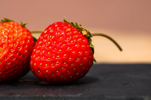 Close up of fresh strawberries showing seeds achenes. Details of fresh ripe red strawberries.