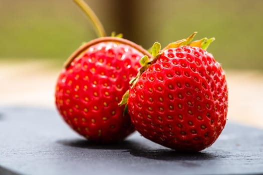 Close up of fresh strawberries showing seeds achenes. Details of fresh ripe red strawberries.