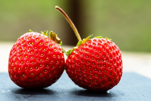 Close up of fresh strawberries showing seeds achenes. Details of fresh ripe red strawberries.