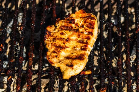 Steak grilled on a charcoal barbeque. Top view of camping tasty barbecue, food concept, food on grill and detail of food on the grill