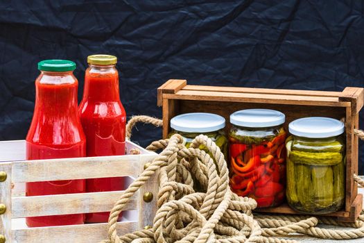 Bottles of tomato sauce, preserved canned pickled food concept isolated in a rustic composition.