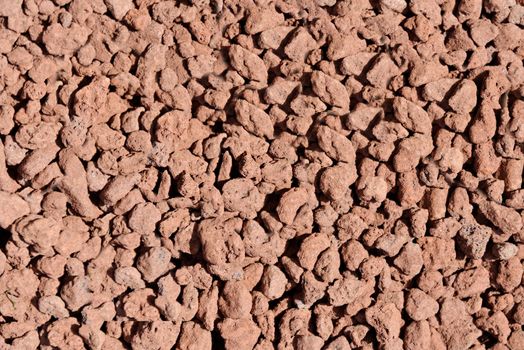 Thermal expanded clay pebbles are used as a nutrient medium in hydroponics. Background close-up of pellets.