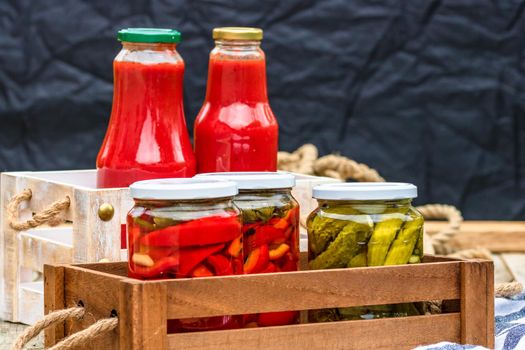 Bottles of tomato sauce, preserved canned pickled food concept isolated in a rustic composition.