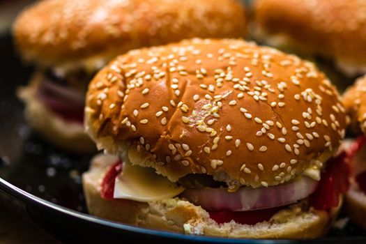 Closeup of fresh homemade tasty burgers on wooden table