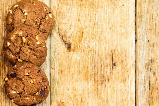 Biscuits on wooden table. Chocolate cookies on the table, breakfast concept. Top view with copy space