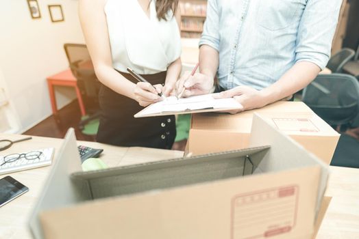 Young entrepreneur checking document with marketing team at home office. Conceptual for small businesses starting own company and online marketing.