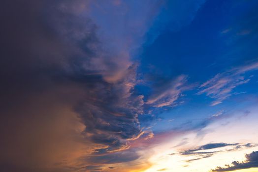 Dramatic sky with storm cloud before raining during sunset.