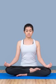 Asian woman keep calm and meditates while practicing yoga to explore the Inner Peace. Yoga and meditation have good benefits for health. Photo concept for Sport and Healthy lifestyle.