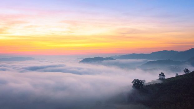 Panorama view of amazing mist moving over the nature mountains during sunrise at mountains area in Thailand.