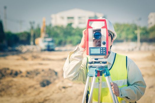 Civil engineer use surveyor equipment theodolite checking construction site for new Infrastructure project. photo concept for engineering work.