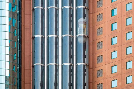 Modern glass elevators or lifts in new business building centre