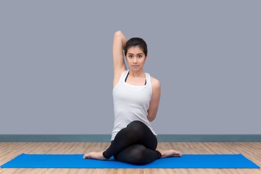 Asian woman practicing yoga pose at sport gym, yoga and meditation have good benefits for health. Photo concept for Sport and Healthy lifestyle