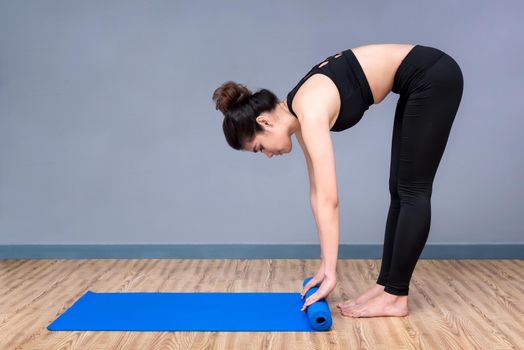 Healthy woman exercising yoga at sport gym, girl doing sport indoor.Photo design for fitness sporty woman and healthcare concept.