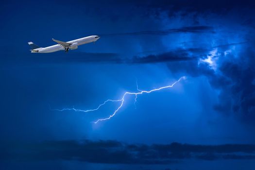 Commercial airplane take off flying over storm clouds and lightning. Elegant Design with copy space for travel concept.