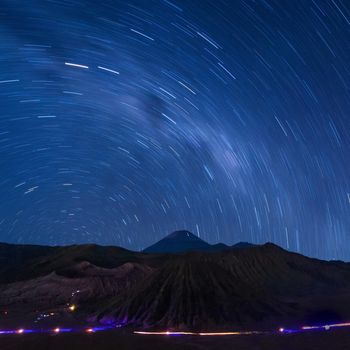 Long exposure capture of star trails above the Bromo Volcano, Indonesia, Astronomy photography.