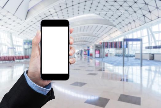 Smart Business women showing smartphone with blank white screen and blurred international airport in background. Elegant Design with copy space for technology and travel transportation concept