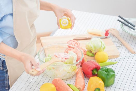 Young asian woman prepare healthy food salad at home. Elegant design for Healthy lifestyle,diet and happiness concept