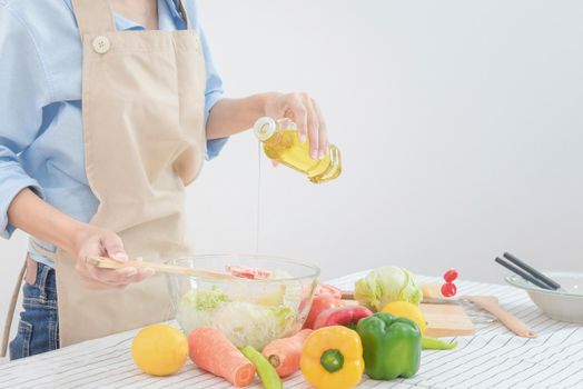 Young asian woman prepare healthy food salad at home. Elegant design for Healthy lifestyle,diet and happiness concept