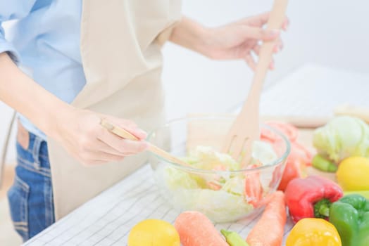 Young asian woman prepare healthy food salad at home. Elegant design for Healthy lifestyle,diet and happiness concept