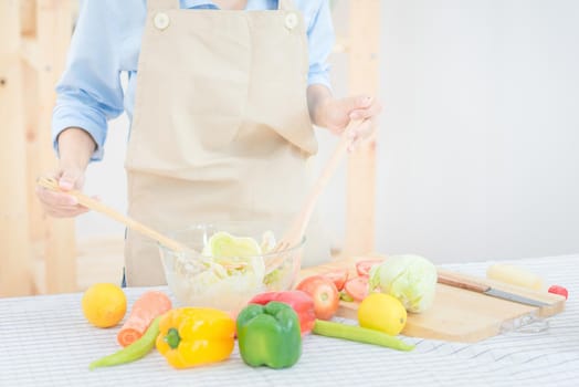 Young asian woman prepare healthy food salad at home. Elegant design for Healthy lifestyle,diet and happiness concept