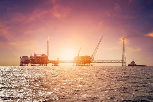 Offshore construction platform for production oil and gas in gulf of Thailand with sunset sky