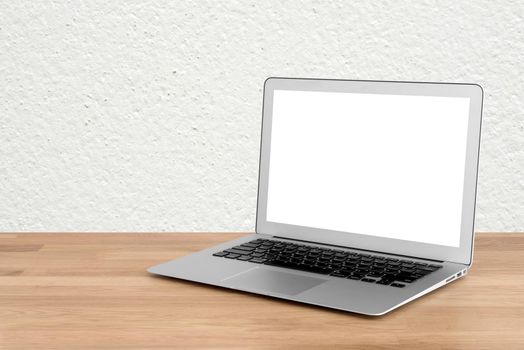 Smart modern laptop with blank white screen on wooden table and modern white wall in background.Elegant Design with copy space for mock up product or graphic display.