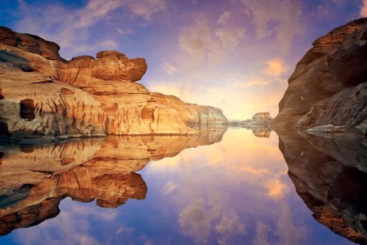 Nature Landscape view of Sand dunes and rock field with water reflection at Sam Phan Bok a canyon by the mekong river in grand canyon of Thailand.