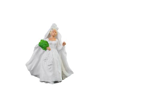 Close up of Miniature people wedding bride isolated with clipping path on white background.Elegant Design with copy space for placement your text, mock up for love and wedding concept