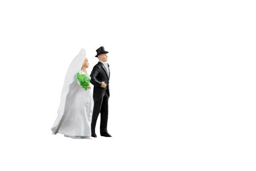 Close up of Miniature people wedding bride and groom couple isolated with clipping path on white background.Elegant Design with copy space for placement your text, mock up for love and wedding concept