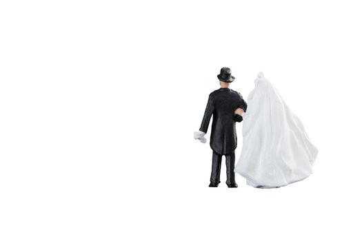 Close up of Miniature people wedding bride and groom couple isolated with clipping path on white background.Elegant Design with copy space for placement your text, mock up for love and wedding concept