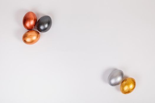 Easter. Multi-colored eggs on a uniform white background with place for text. View from above.