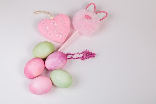 Easter. Multi-colored eggs with twigs, on a white background with a place for text. View from above