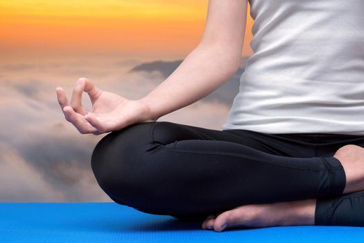 Young woman keep calm and meditates while practicing yoga to explore the Inner Peace. Yoga and meditation have good benefits for health. Photo concept for Yoga Sport and Healthy lifestyle.