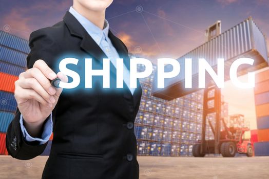 Smart business woman is writing shipping word with forklift lifting cargo container and cargo containers stack in background for global transportation import,export and logistic business concept