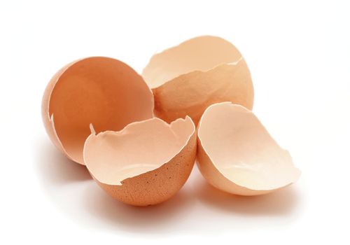 Opened cracked egg shells on white background.