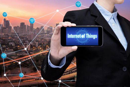 Young Smart business woman is using smart technology of internet of things in smart city for global business connection. Photo design for smart city and smart technology internet of things concept