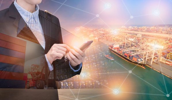 Double exposure asian business woman use smart technology with container shipping boat at shipping yard.Photo concept for Global business shipping,Logistic,Import and Export industry.