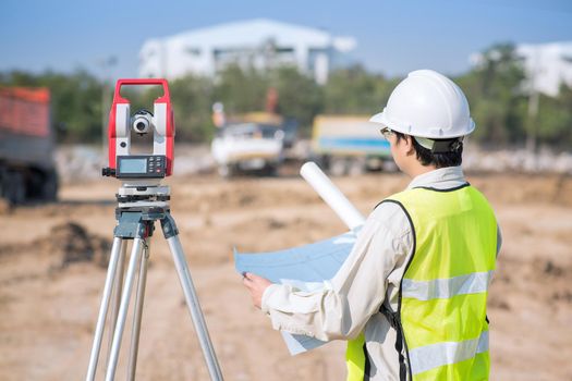 Construction engineer checking construction drawing at site area for new Infrastructure construction project