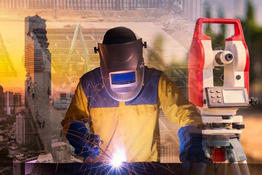 Double exposure welding worker welding steel structure with building and construction engineer at construction site for construction engineering work concept 