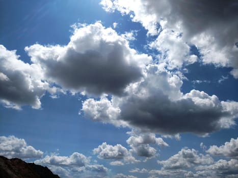 Clouds in the morning sunlight against the blue sky.