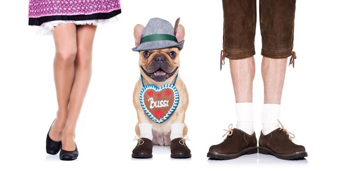 french bulldog  dog with  gingerbread heart and bavarian couple of family owners , isolated on white background