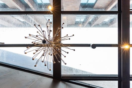 Upward view to beautiful chandelier full of thin metal branches