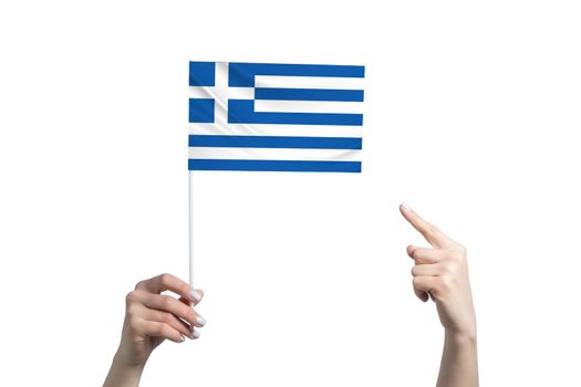 A beautiful female hand holds a Greece flag to which she shows the finger of her other hand, isolated on white background.