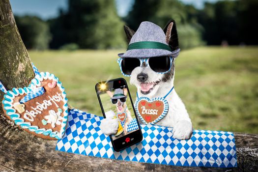 bavarian poodle  dog taking a selfie holding  a beer mug  outdoors by the river and mountains  , ready for the beer party celebration festival in munich